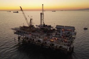 Large Gas and Oil Offshore Drilling Rig in Calm Waters on a Clear Evening at Dusk With Catalina Island in the Distant Background